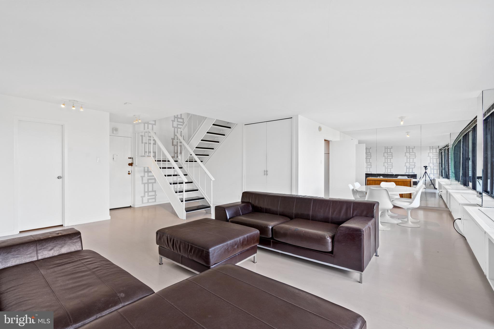 2510 Virginia Avenue Northwest, Unit 708N Washington, DC 20037 - Photo 3 of 37 a living room with furniture and a book shelf
