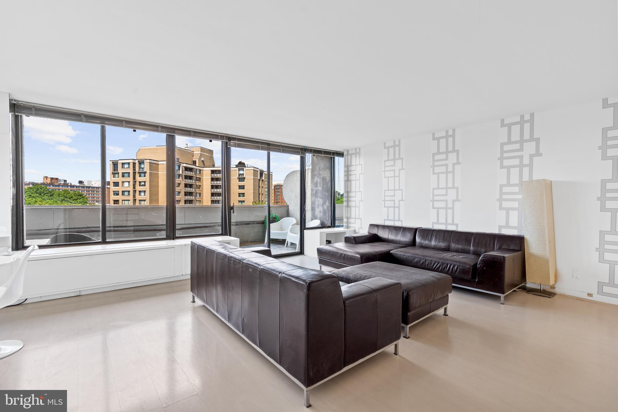2510 Virginia Avenue Northwest, Unit 708N Washington, DC 20037 - Photo 4 of 37 a living room with furniture and large windows