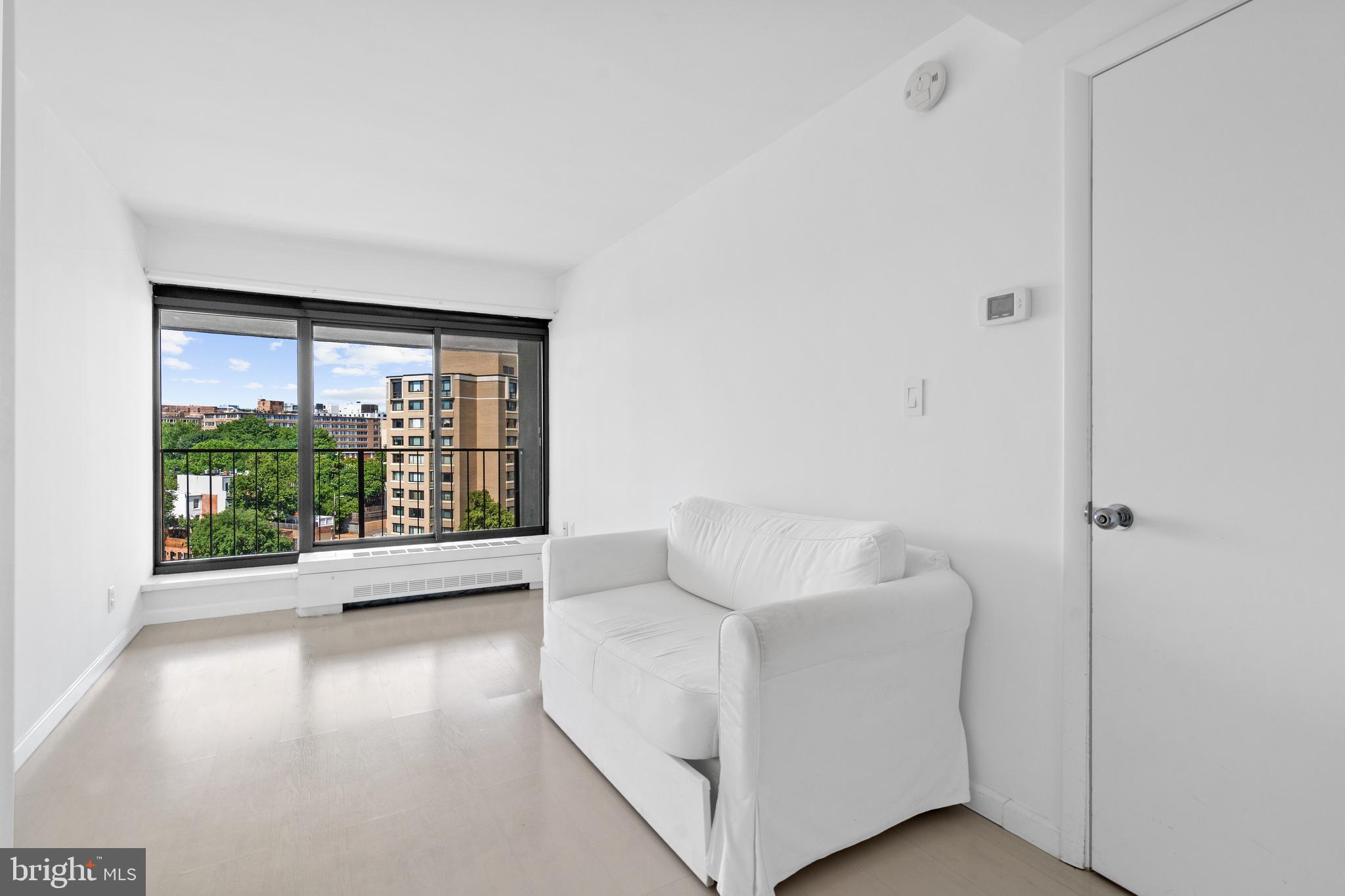 2510 Virginia Avenue Northwest, Unit 708N Washington, DC 20037 - Photo 8 of 37 a view of utility room and bedroom with wooden floor