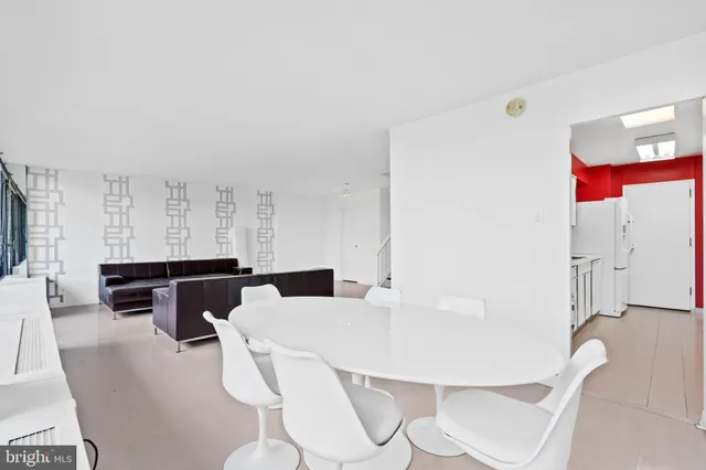 a kitchen with stainless steel appliances kitchen island granite countertop a table and chairs