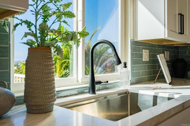 a stove top oven sitting inside of a kitchen