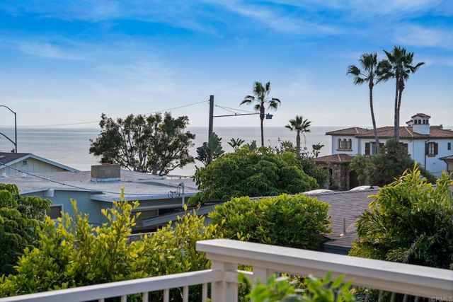 a bedroom with a bed and a flat tv screen on the dresser