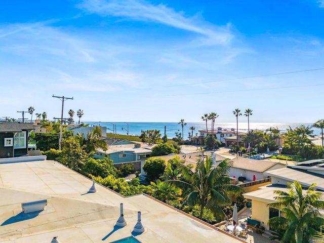 a view of an empty room with wooden floor and closet