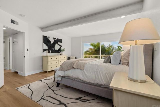a view of a dining room with furniture and a potted plant
