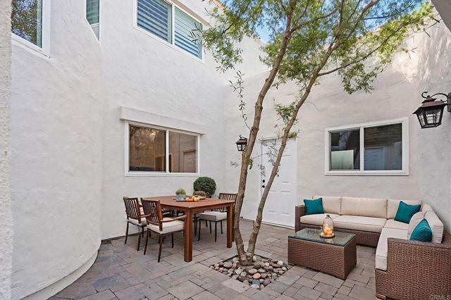 a kitchen with a sink white cabinets and white appliances