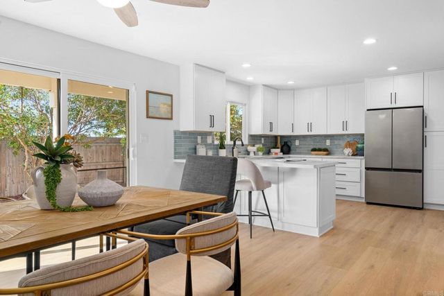 a spacious bedroom with a bed and a chandelier