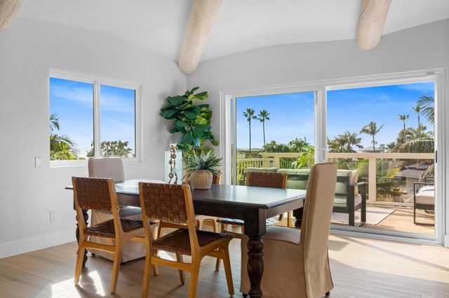 a kitchen with stainless steel appliances a refrigerator a stove a sink dishwasher and white cabinets with wooden floor