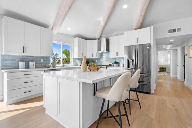 a dining room with furniture and a kitchen view