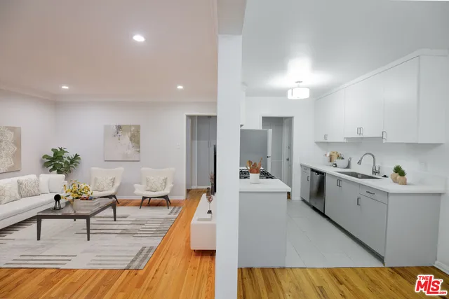 a living room with kitchen island furniture and a kitchen view