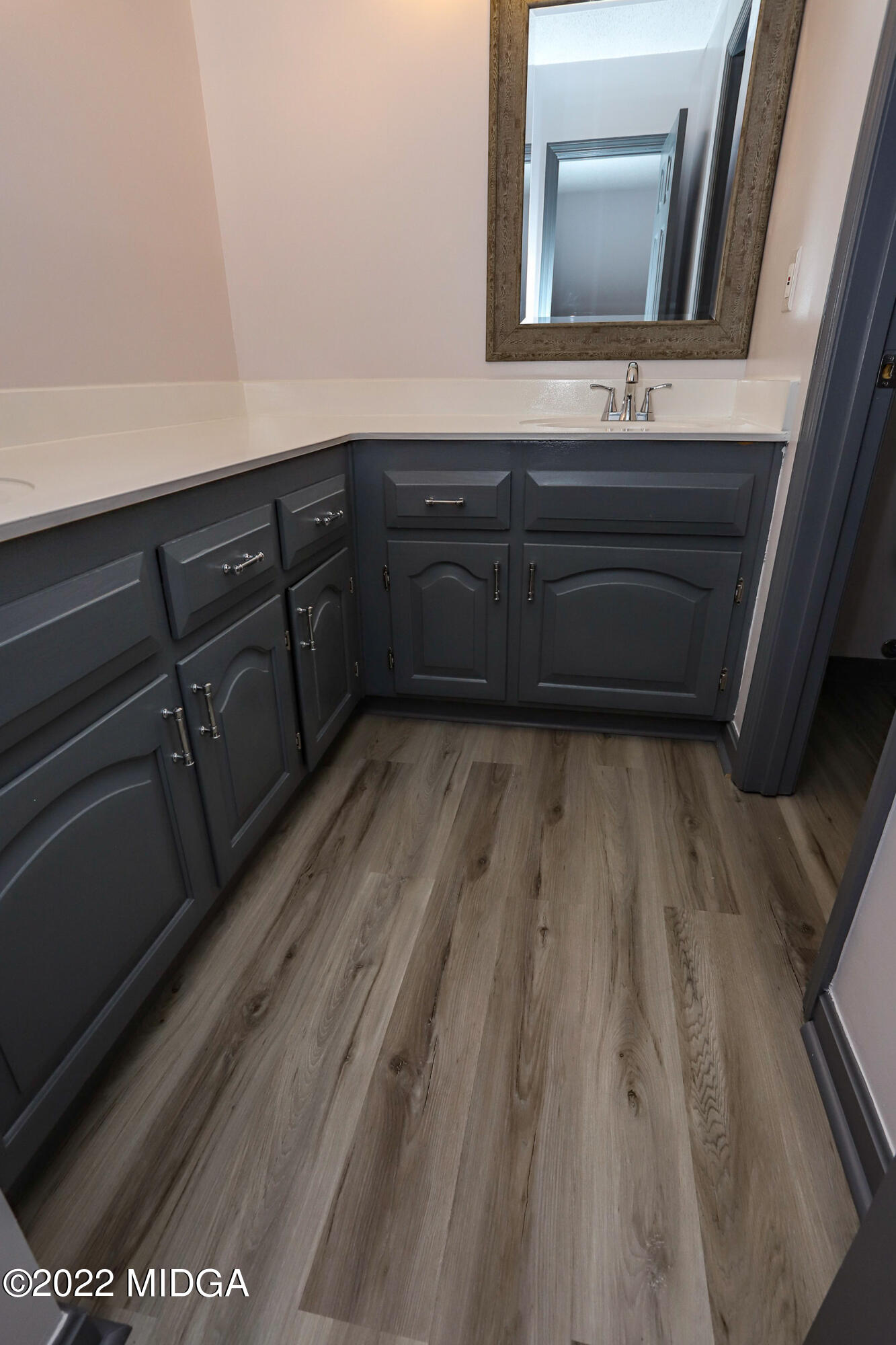 107 Ridge Circle Macon, GA 31216 - Photo 26 of 80 a bathroom with a sink a mirror and wooden floor