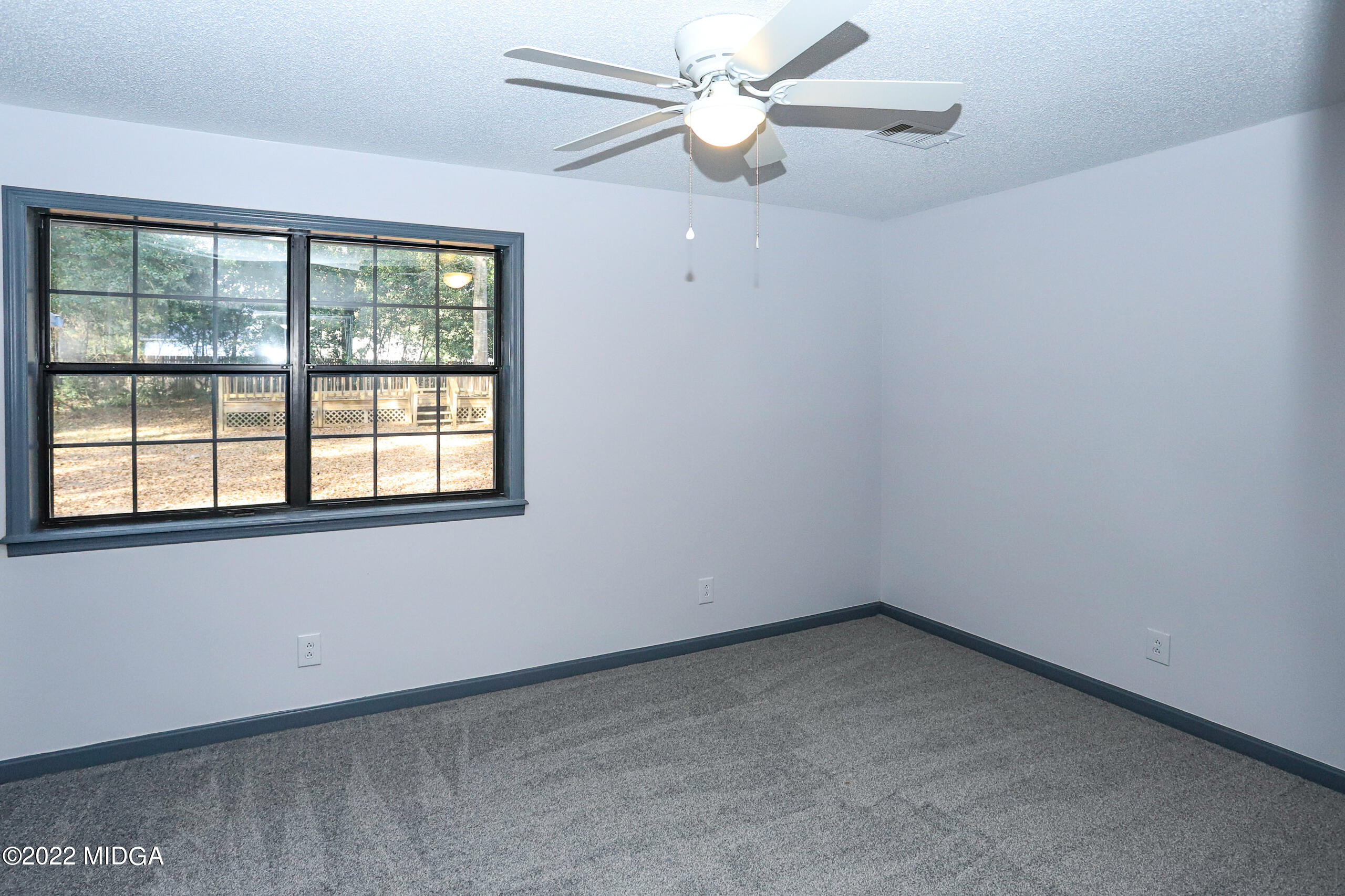 107 Ridge Circle Macon, GA 31216 - Photo 29 of 80 an empty room with a window and a fan