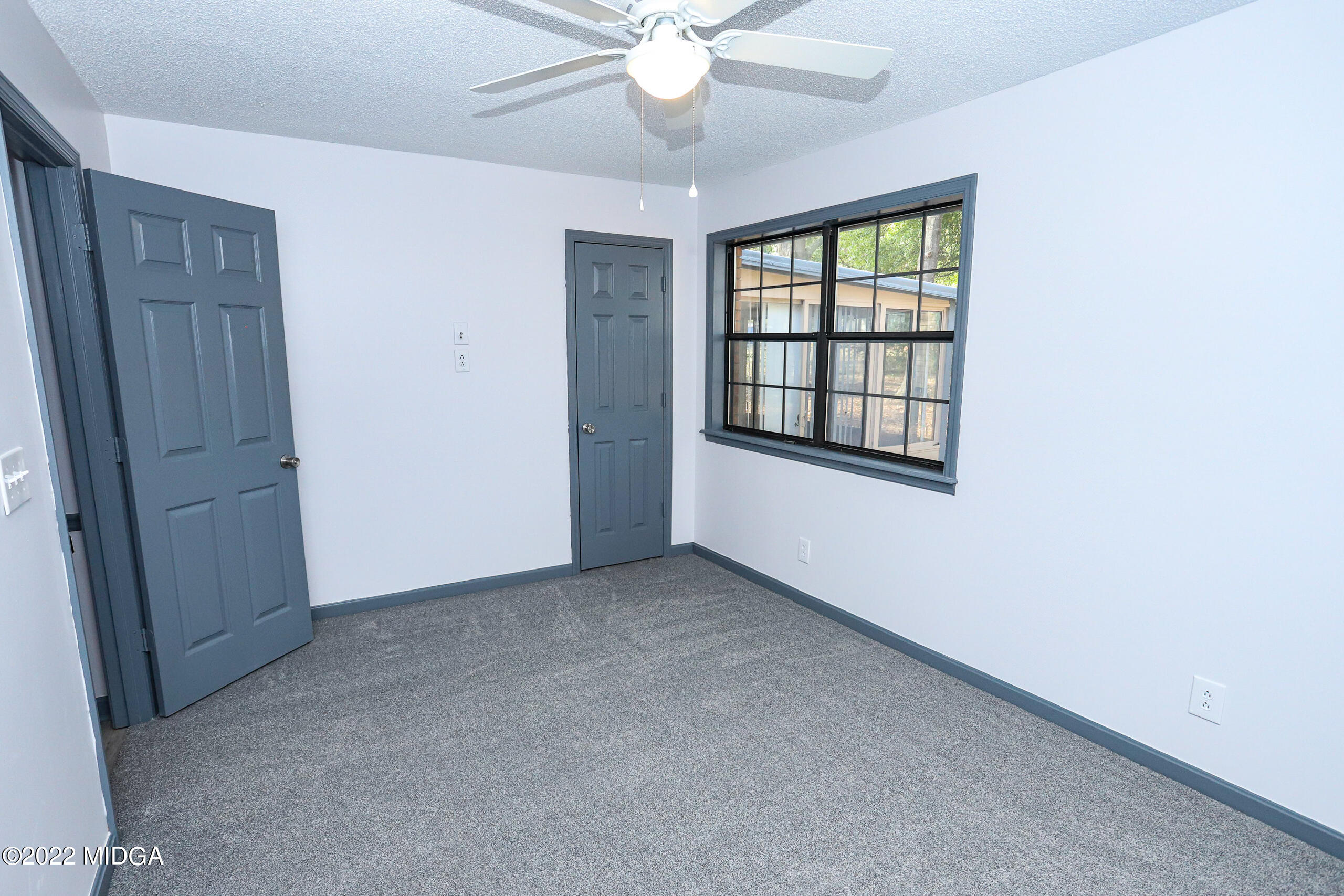 107 Ridge Circle Macon, GA 31216 - Photo 32 of 80 an empty room with windows and ceiling fan