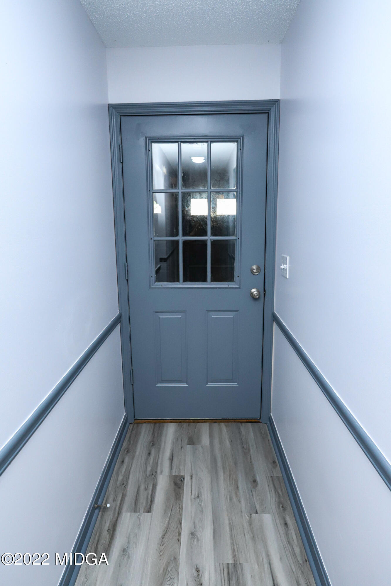 107 Ridge Circle Macon, GA 31216 - Photo 36 of 80 a view of a hallway with wooden floor and a window