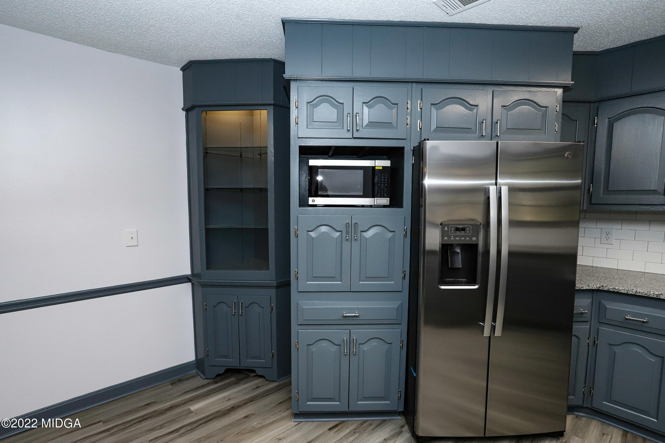 107 Ridge Circle Macon, GA 31216 - Photo 62 of 80 a kitchen with a refrigerator and wooden cabinets