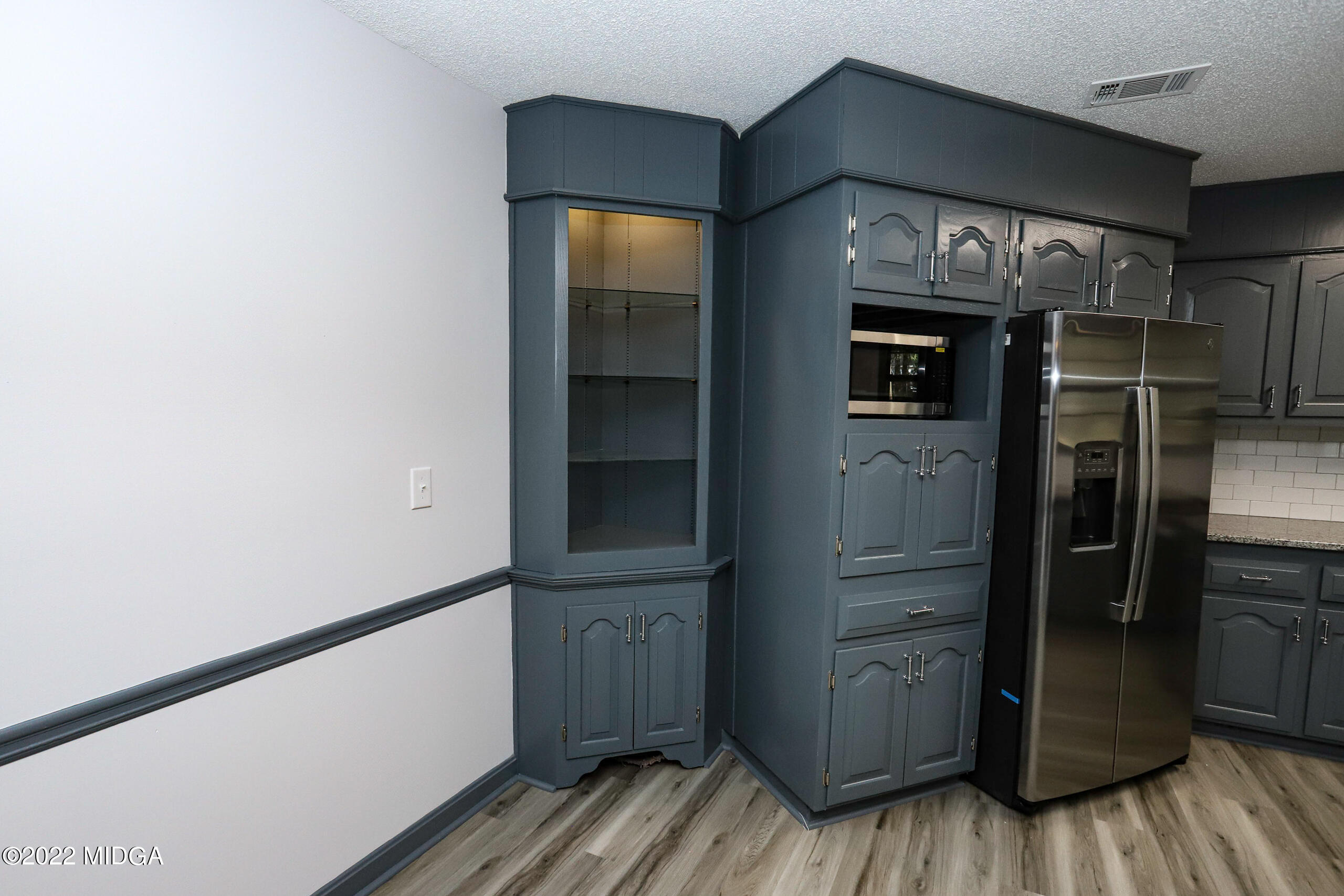 107 Ridge Circle Macon, GA 31216 - Photo 63 of 80 a kitchen with stainless steel appliances a refrigerator and wooden floor