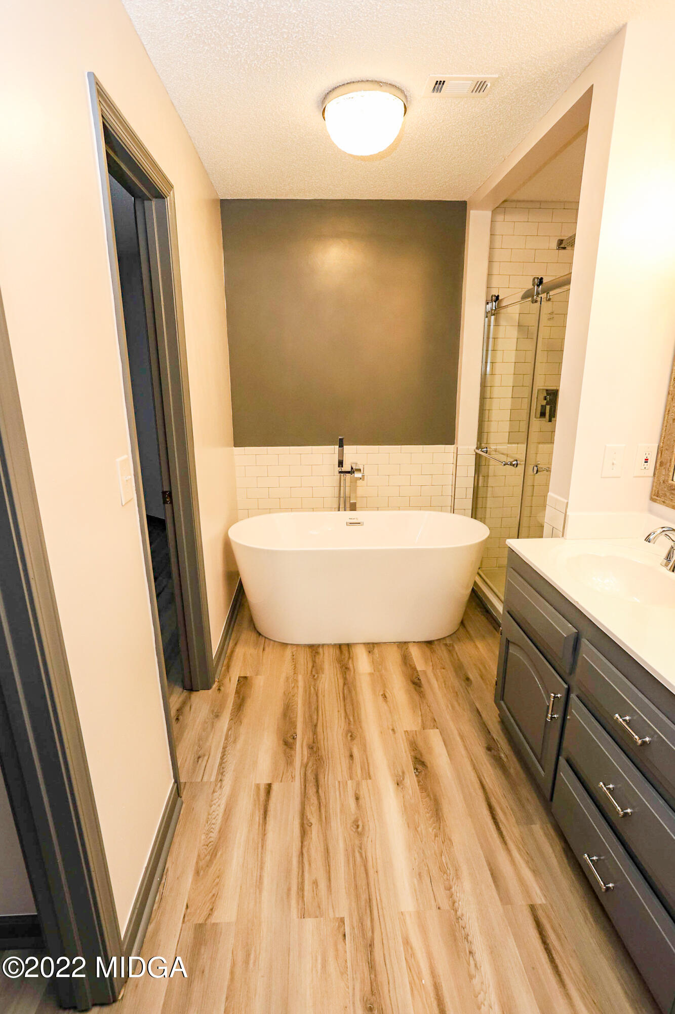 107 Ridge Circle Macon, GA 31216 - Photo 66 of 80 a bathroom with a sink a mirror and a bathtub