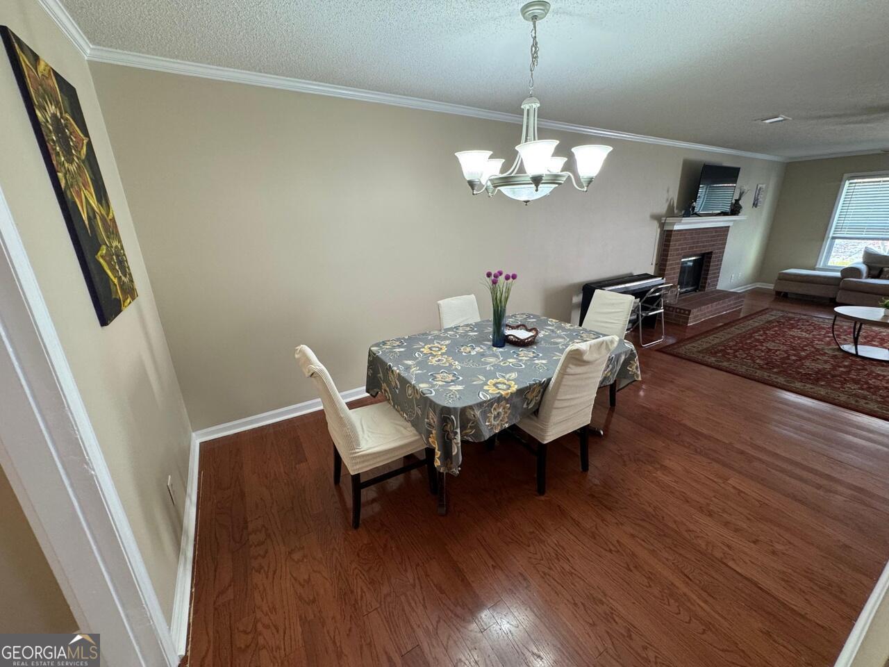 113 Manor Row Macon, GA 31210 - Photo 5 of 19 a view of a dining room with furniture wooden floor and a chandelier