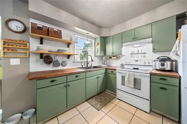 a kitchen with a sink cabinets and window