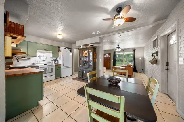 a kitchen with a table chairs and a refrigerator