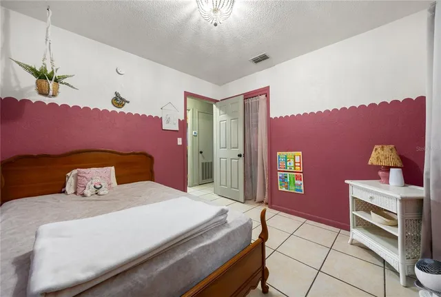 a bedroom with a bed and a dresser in it