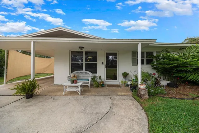 a view of a patio with table and chairs under an umbrella