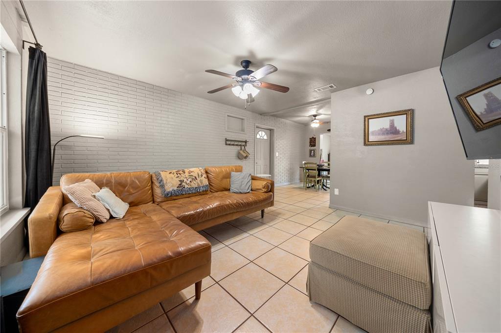 4023 Northeast 7th Street Ocala, FL 34470 - Photo 7 of 32 a living room with furniture and a ceiling fan