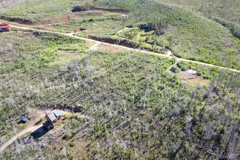 a view of a forest with a yard