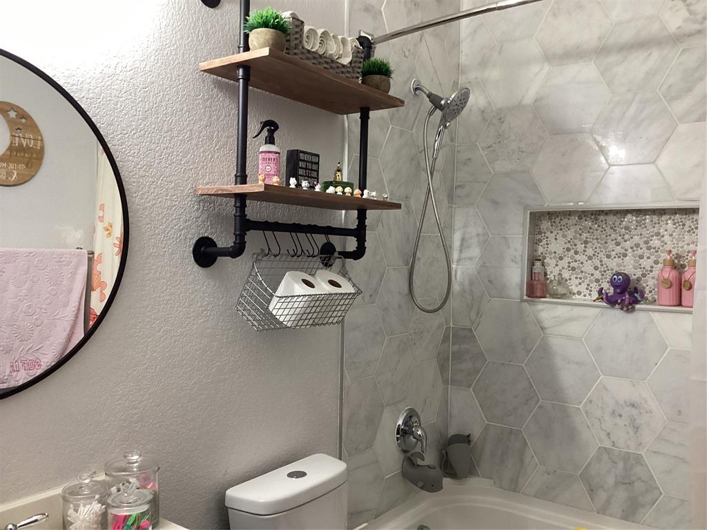 10320 Point Lobos Trail Fort Worth, TX 76177 - Photo 21 of 33 Shower featuring hexagonal tile surround, built-in niche with mosaic tile backing, and a chrome shower head