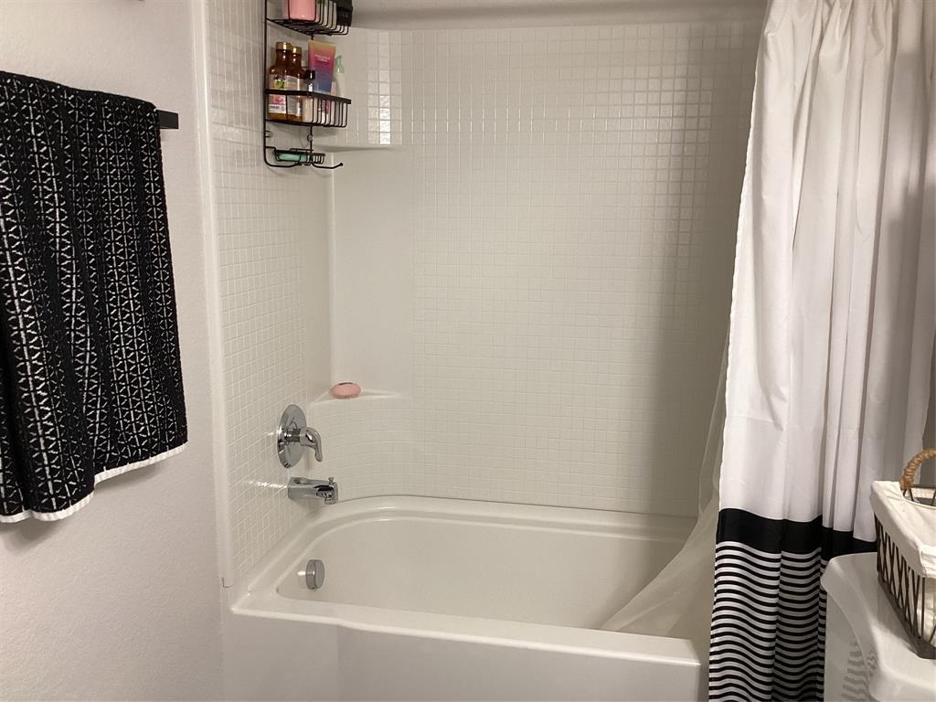 10320 Point Lobos Trail Fort Worth, TX 76177 - Photo 27 of 33 Bathtub and shower combination featuring a chrome faucet and a white tiled shower surround