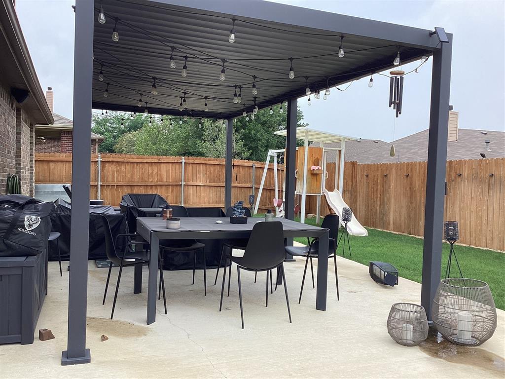 10320 Point Lobos Trail Fort Worth, TX 76177 - Photo 33 of 33 Expansive concrete patio featuring a dark-toned pergola with string lighting