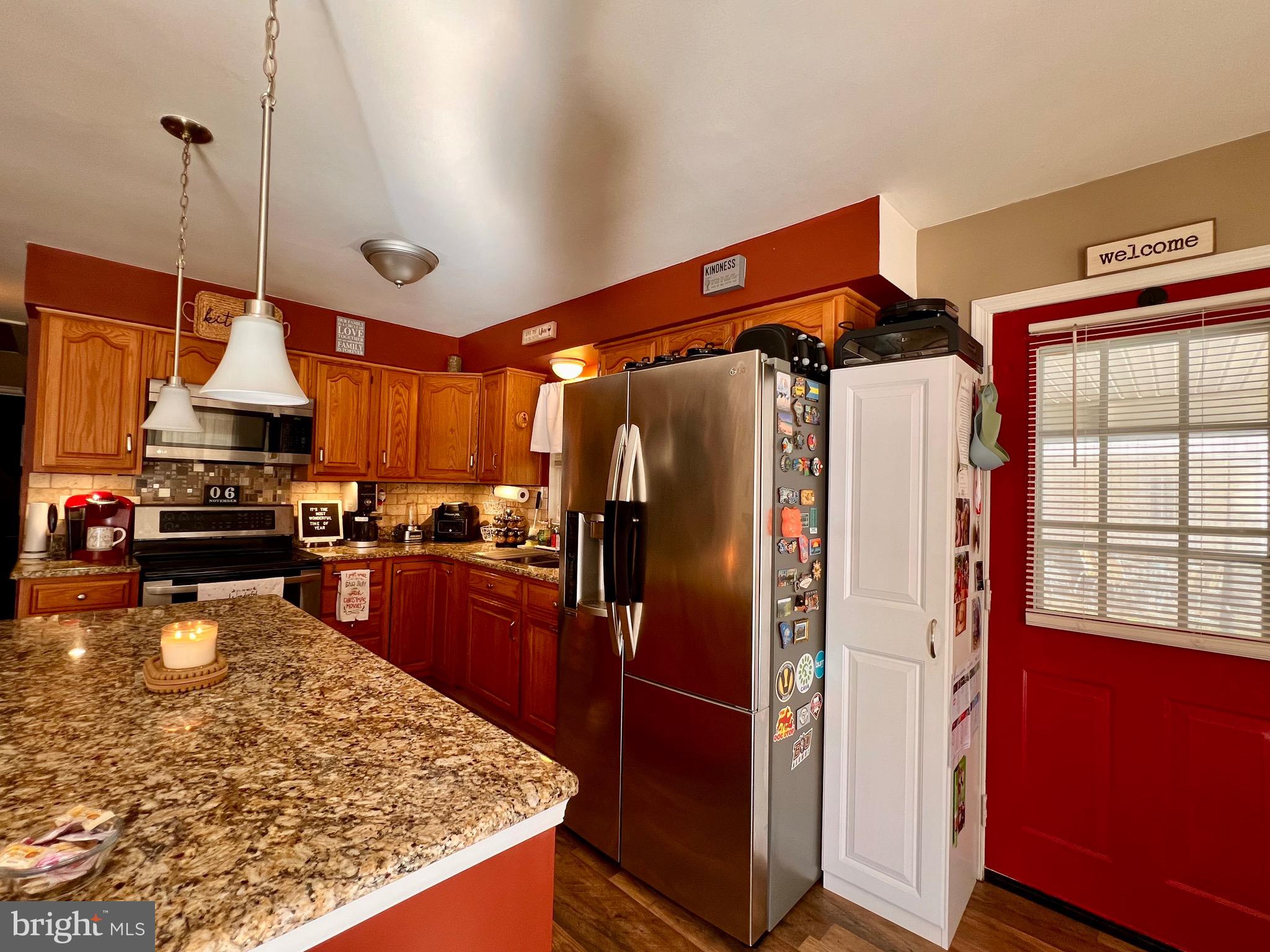 111 Anderson Street Middletown, DE 19709 - Photo 11 of 48 a kitchen with stainless steel appliances granite countertop a refrigerator a stove and a wooden floors