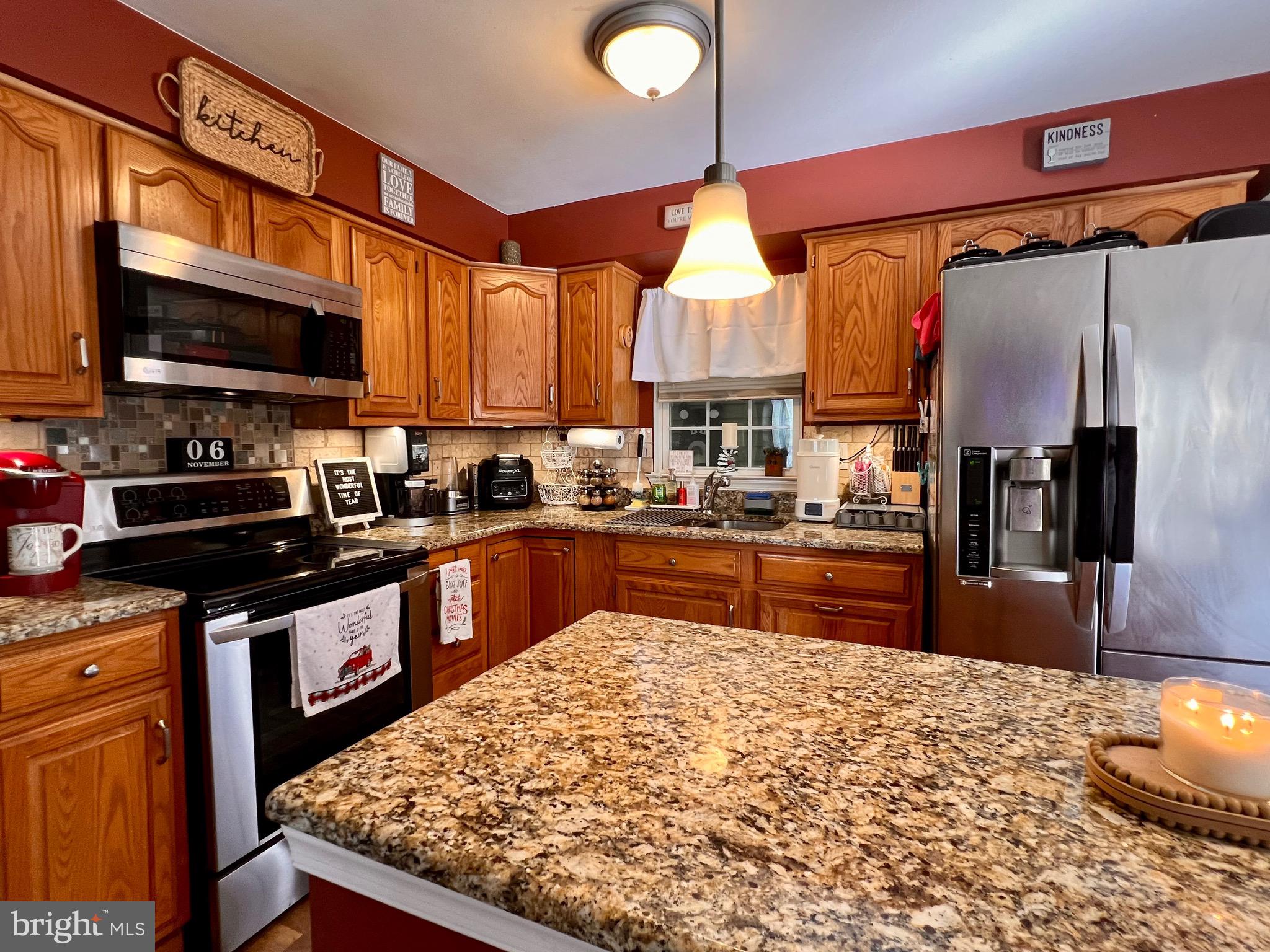 111 Anderson Street Middletown, DE 19709 - Photo 22 of 48 a kitchen with stainless steel appliances kitchen island granite countertop a sink stove and refrigerator