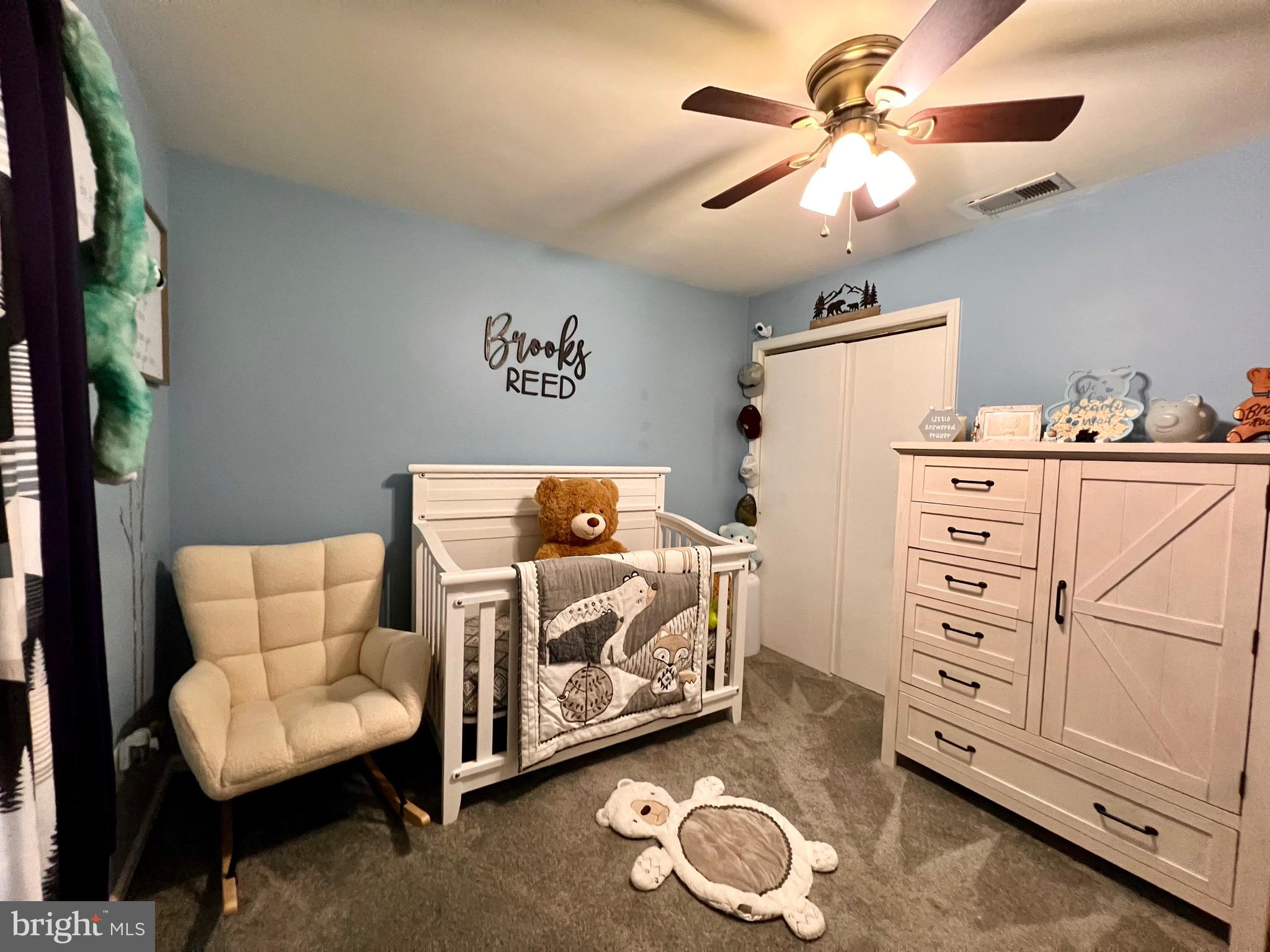 111 Anderson Street Middletown, DE 19709 - Photo 29 of 48 a bedroom with a bed and a chandelier