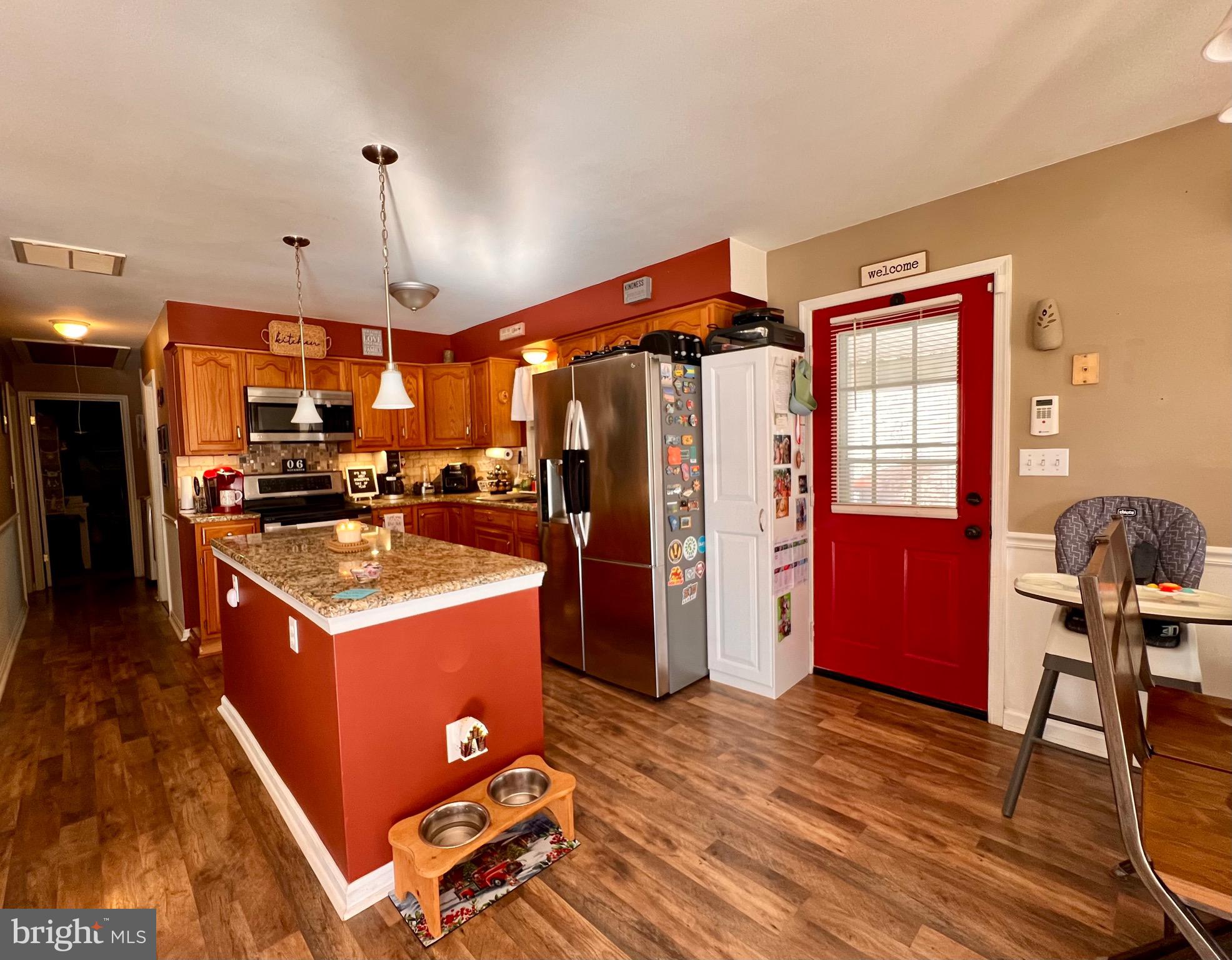 111 Anderson Street Middletown, DE 19709 - Photo 9 of 48 a kitchen with a stove a refrigerator and a dining table