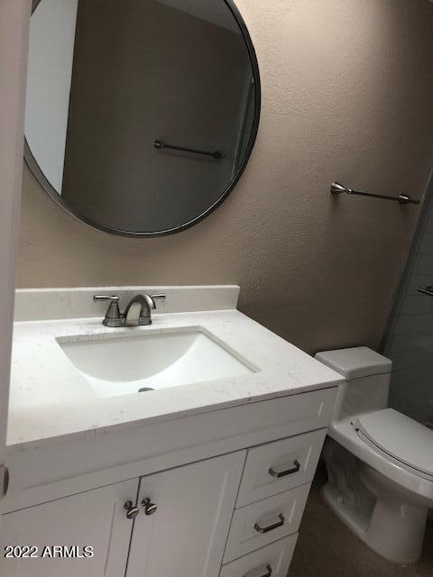214 East Ruth Avenue, Unit 307 Phoenix, AZ 85020 - Photo 11 of 12 a bathroom with a sink toilet and mirror