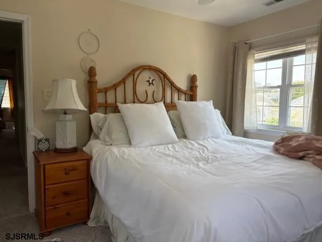 a bedroom with a bed and a window