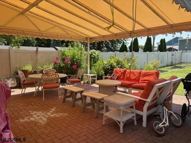 a view of a patio with table and chairs and potted plants