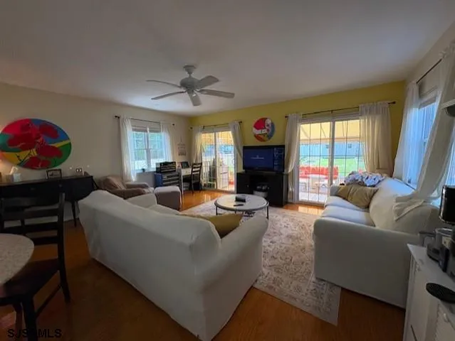 a living room with furniture a fireplace and a window