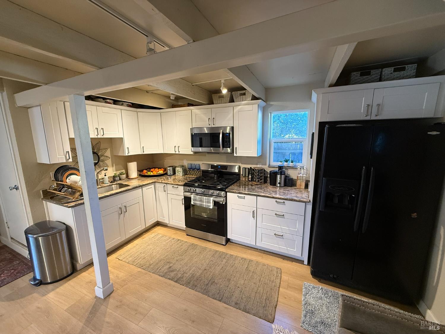930 Morgan Street, Unit 3 Santa Rosa, CA 95401 - Photo 25 of 53 a kitchen with granite countertop a refrigerator stove microwave and sink