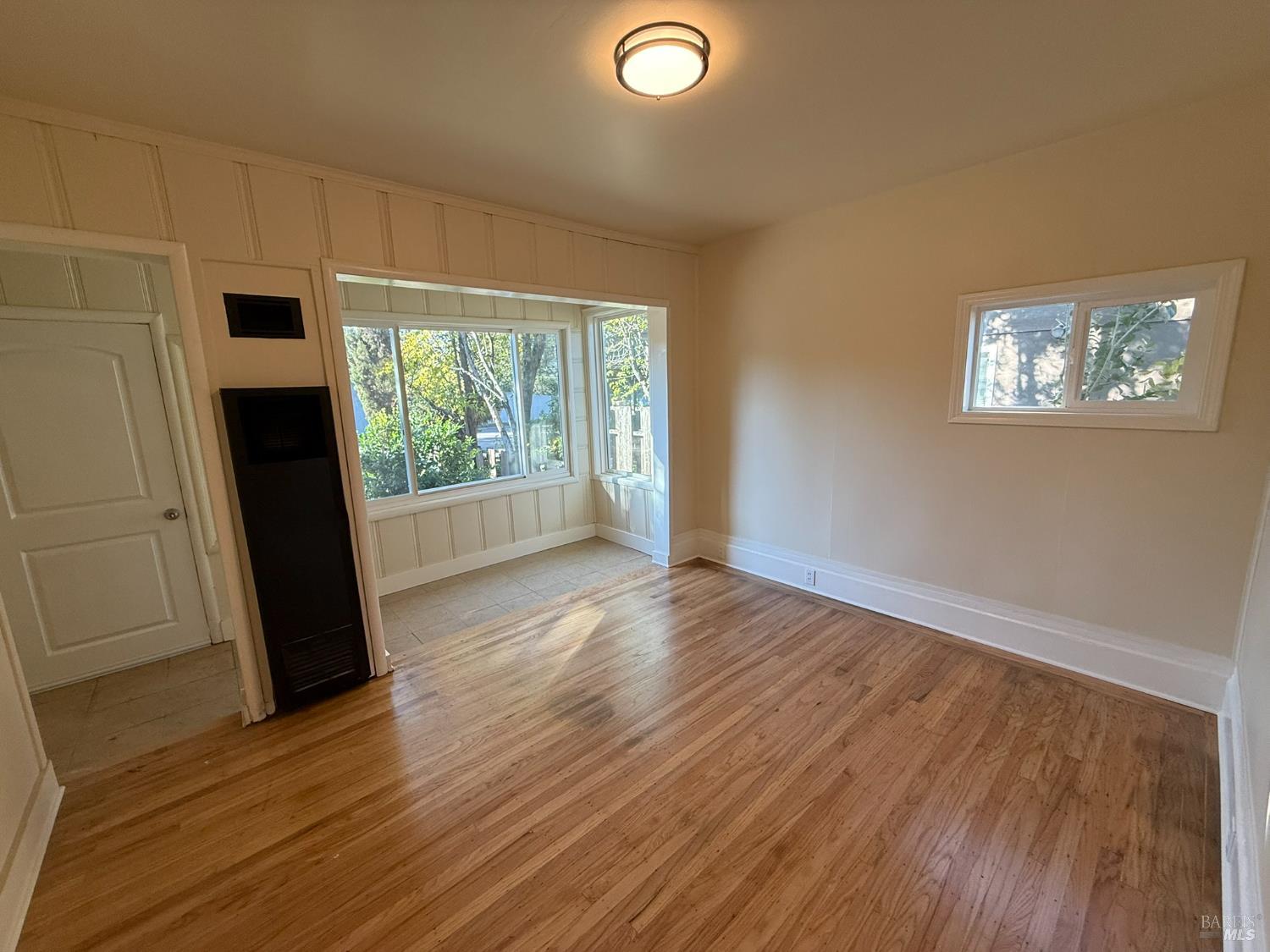 930 Morgan Street, Unit 3 Santa Rosa, CA 95401 - Photo 5 of 53 an empty room with wooden floor and windows