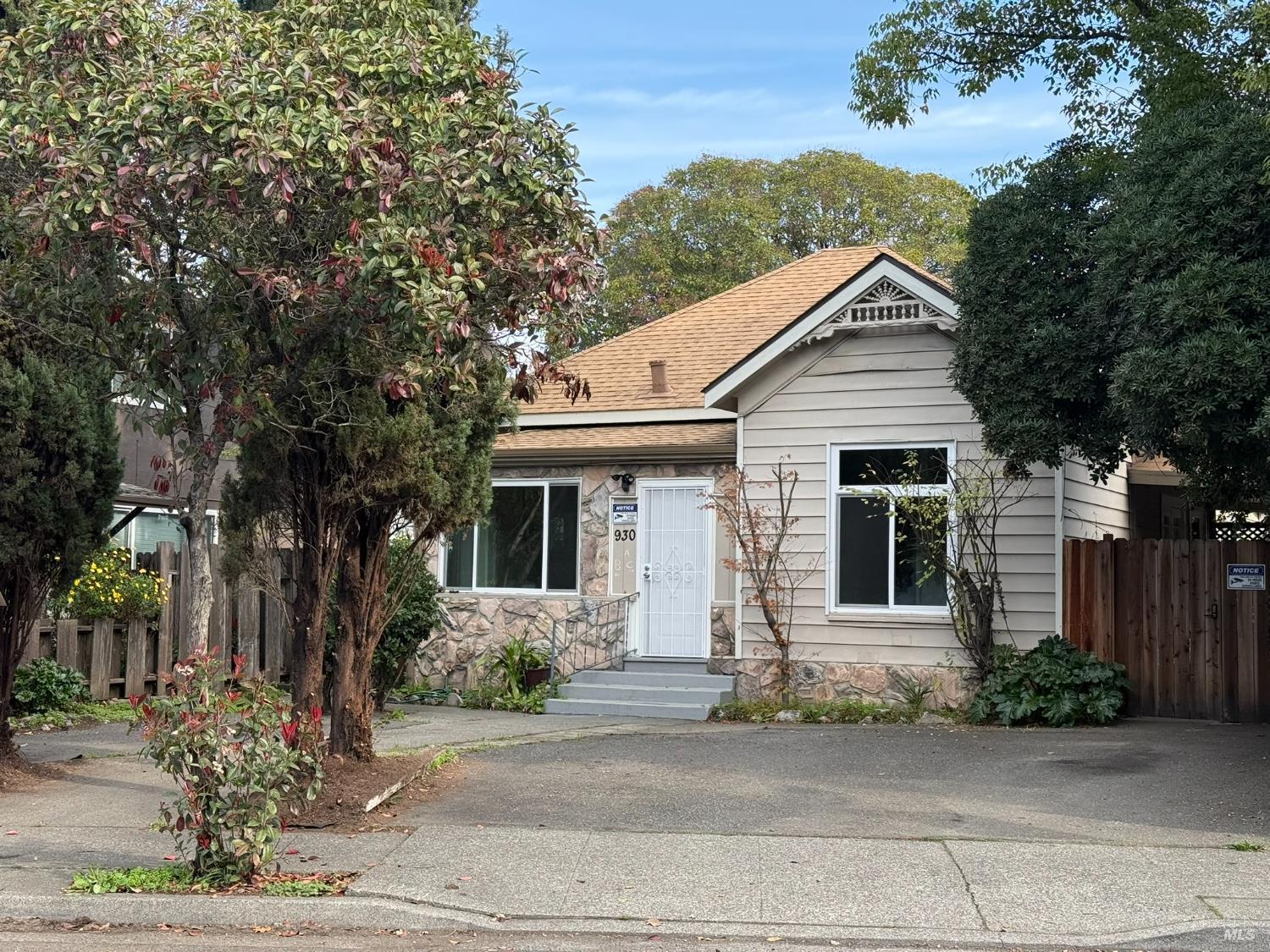 930 Morgan Street, Unit 3 Santa Rosa, CA 95401 - Photo 51 of 53 a view of a white house with large windows and a small yard
