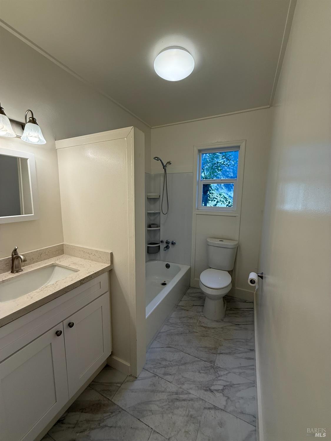 930 Morgan Street, Unit 3 Santa Rosa, CA 95401 - Photo 6 of 53 a spacious bathroom with a granite countertop sink toilet and a mirror