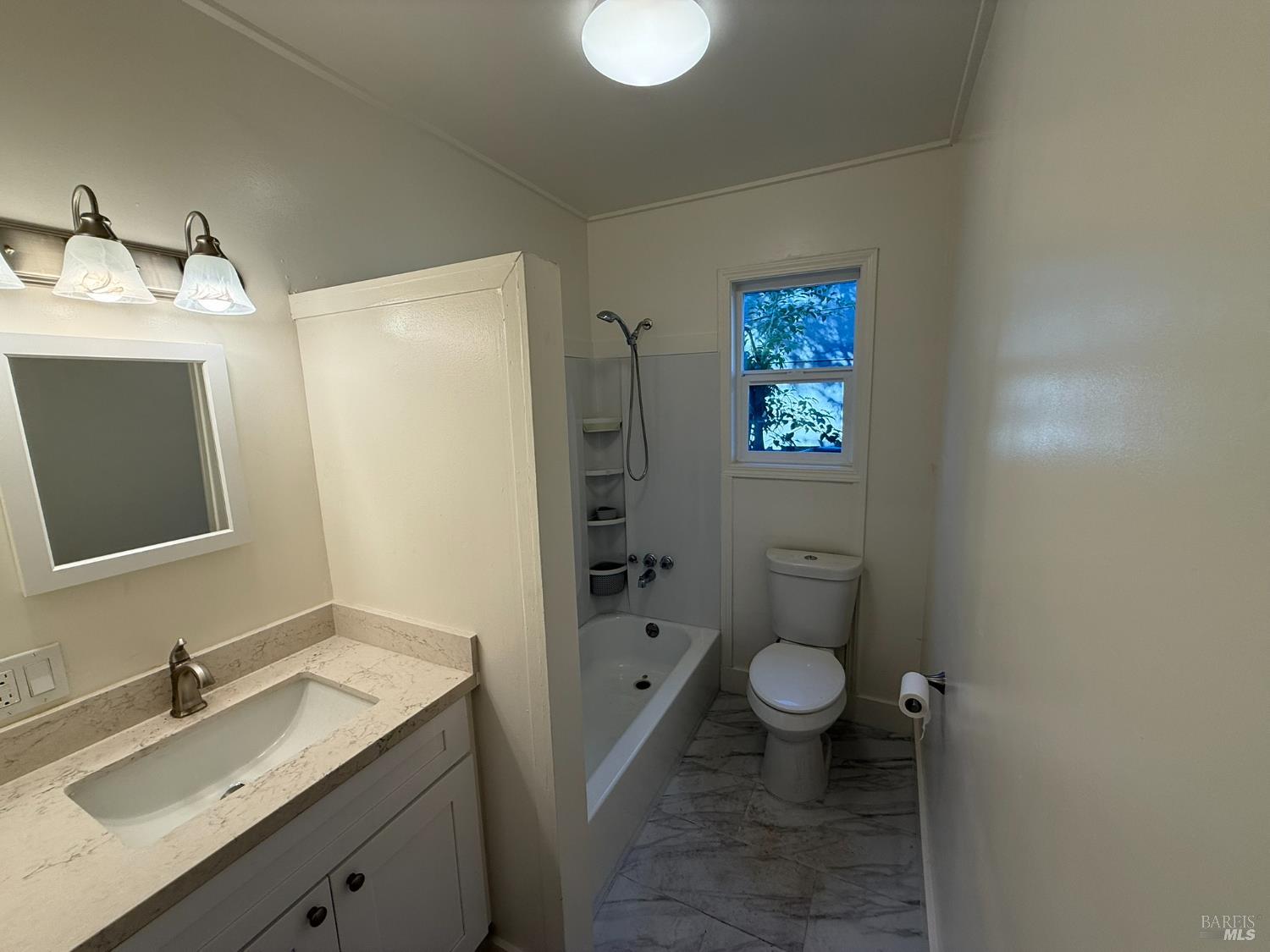 930 Morgan Street, Unit 3 Santa Rosa, CA 95401 - Photo 7 of 53 a bathroom with a toilet sink and mirror