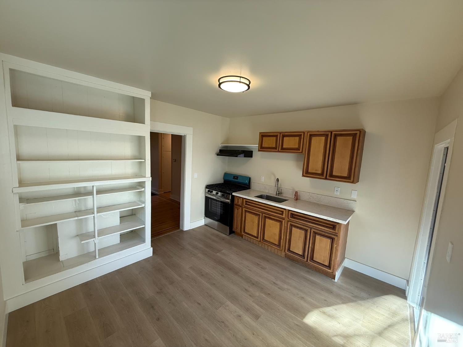 930 Morgan Street, Unit 3 Santa Rosa, CA 95401 - Photo 8 of 53 a kitchen with stainless steel appliances wooden floor and view living room