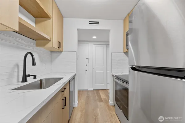 a kitchen with a sink and a refrigerator