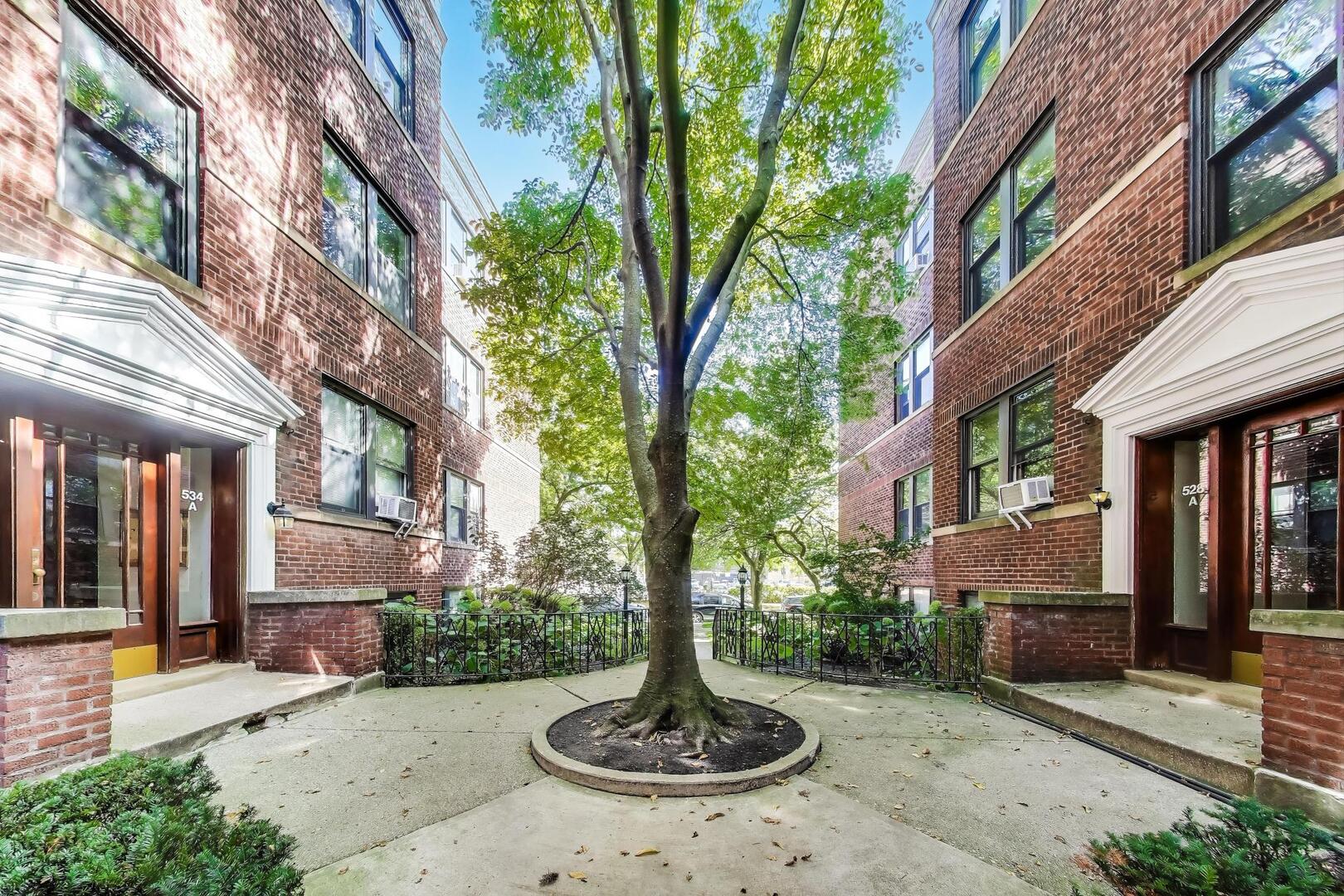 530 Sheridan Road, Unit 2B Evanston, IL 60202 - Photo 3 of 28 a front view of a house with yard and tree s
