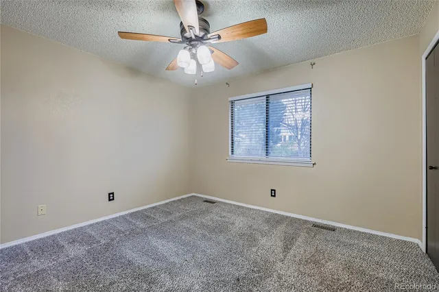 a view of an empty room with a fan