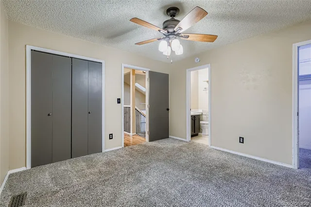 a view of a livingroom with a chandelier fan