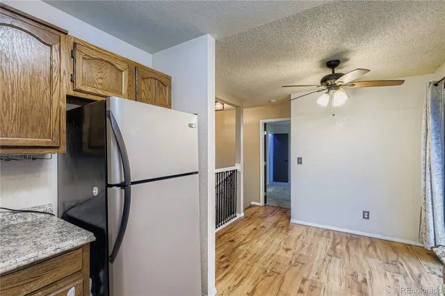 a white refrigerator freezer and a stove sitting inside of a kitchen