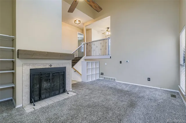 a view of empty room with fireplace and stairs